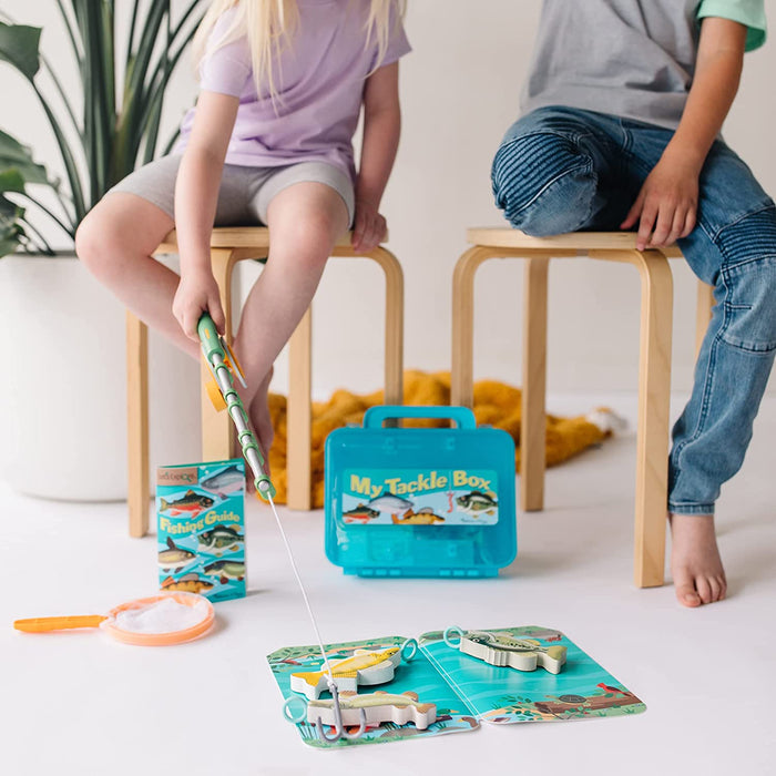 boy fishig with tackle box Melissa & Doug Let's Explore Fishing Play Set
